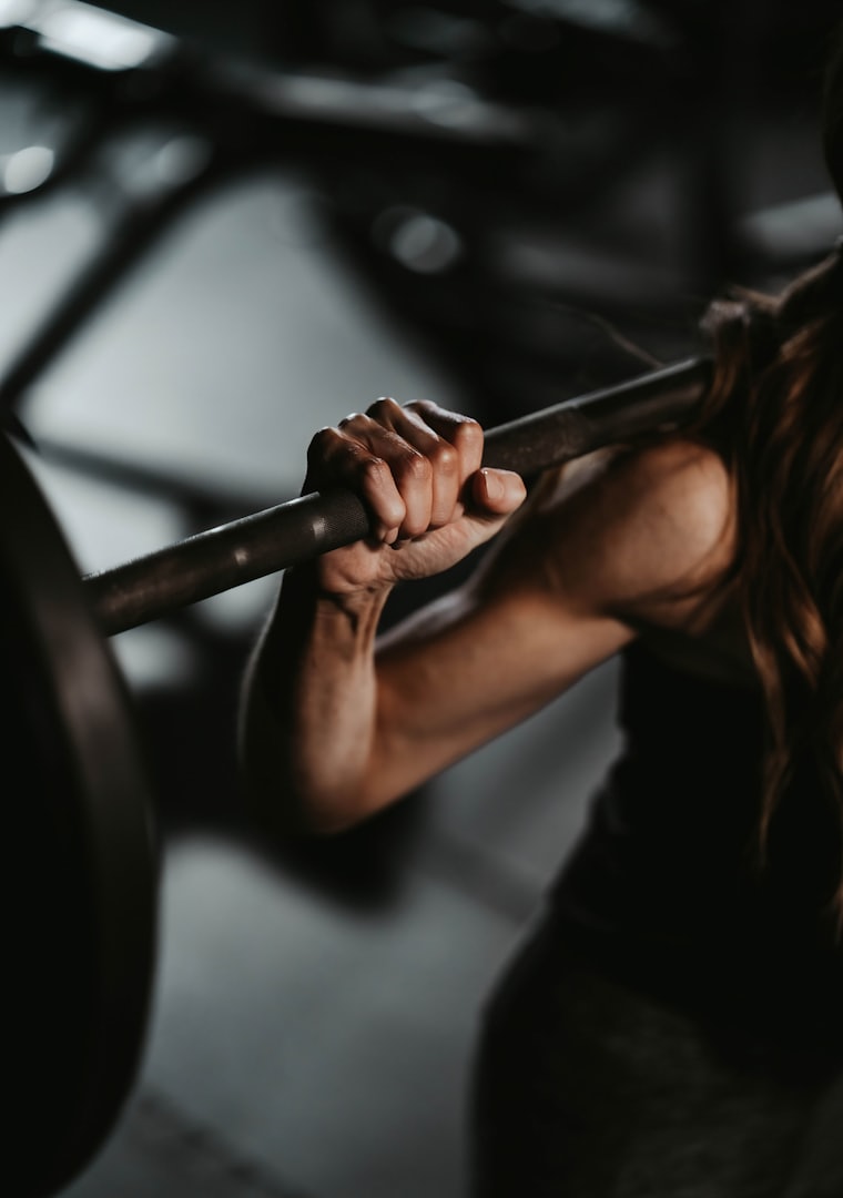 A barbell mid-lift in a gym.